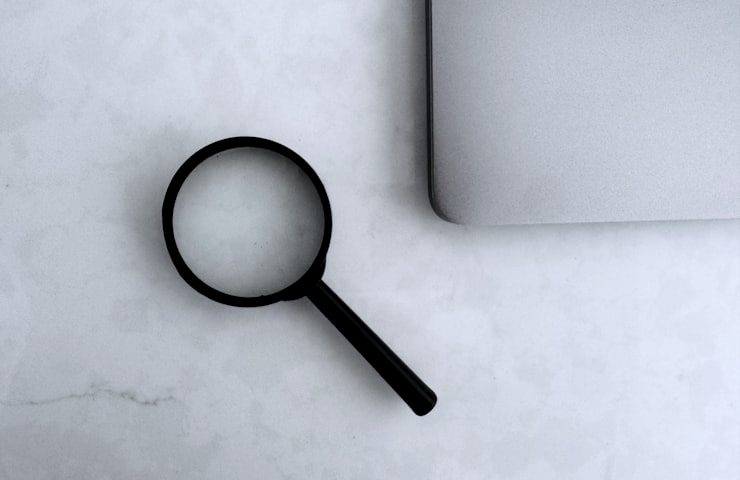 Magnifying glass on a desk, representing investigation work